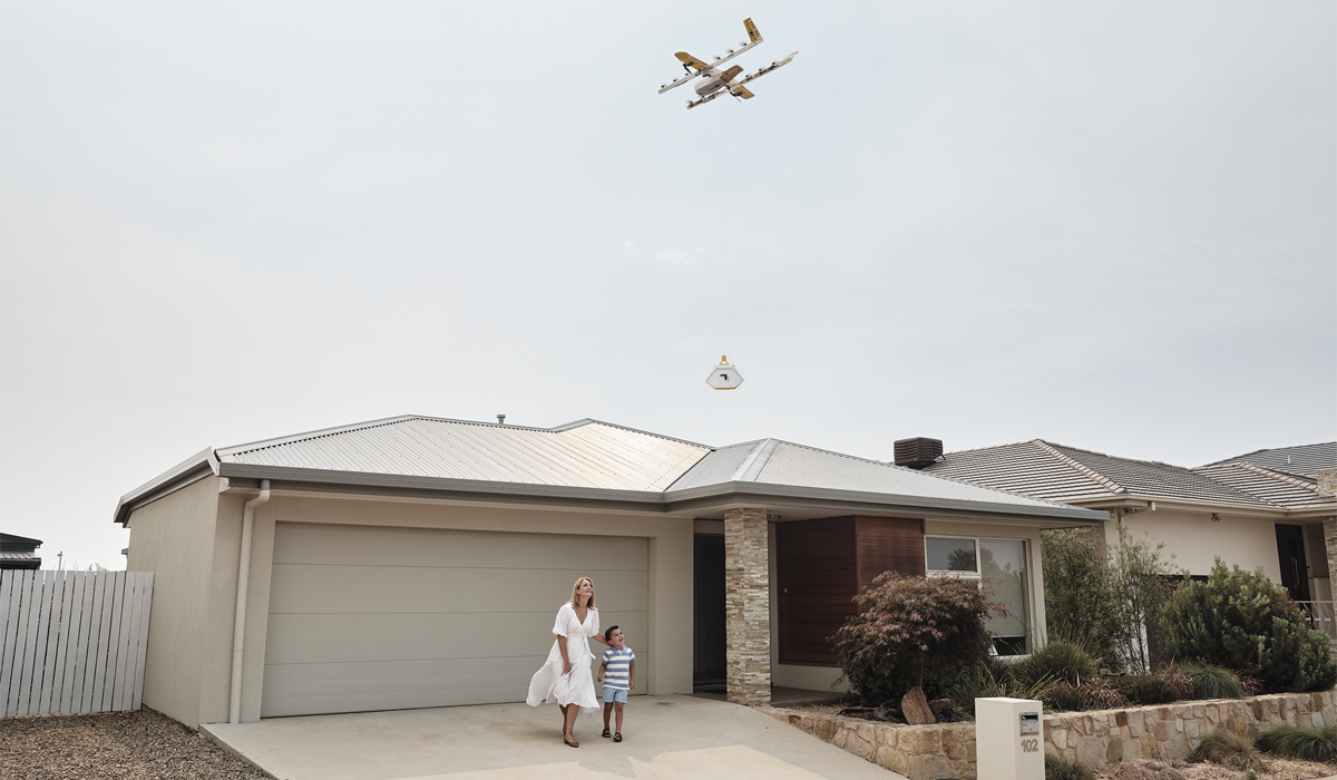 A Wing drone lowering a package to a customer's doorstep